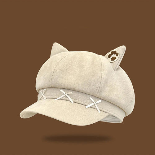 Beige cap with cat ears and paw print on a brown background