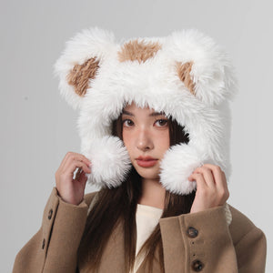 Person wearing a brown coat and white furry hat with animal ears on a gray background