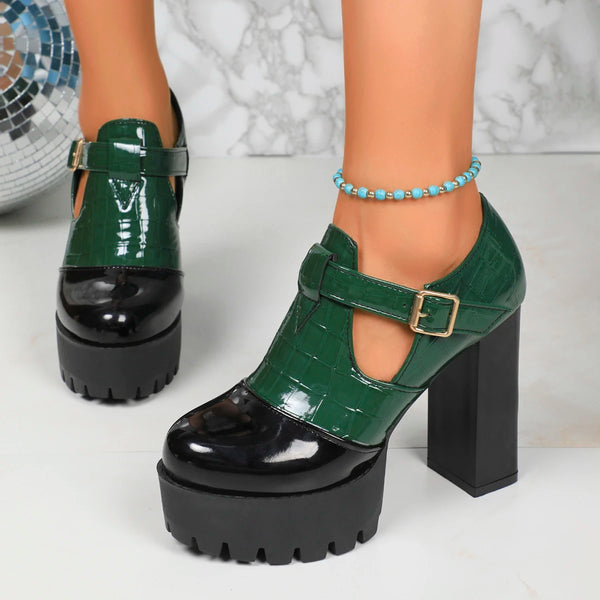 Green platform shoes with black soles worn by a person on a white background