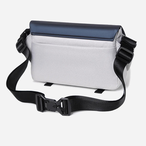 White and black crossbody bag on a light gray background