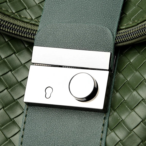 Green leather belt with a silver buckle on a green woven background