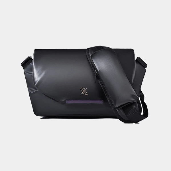 Black messenger bag with a brand logo on a light gray background