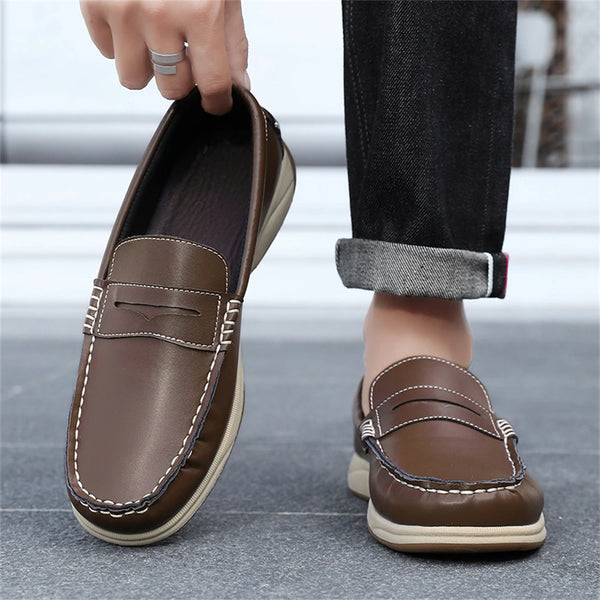 Brown loafers being worn with a blurred background