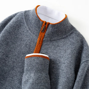Gray sweater with orange zipper and trim on a white background