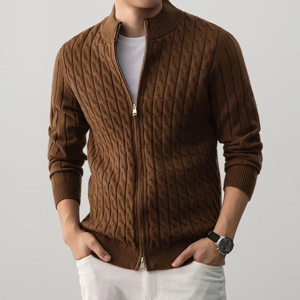 Brown cable knit sweater worn by a person on a light gray background