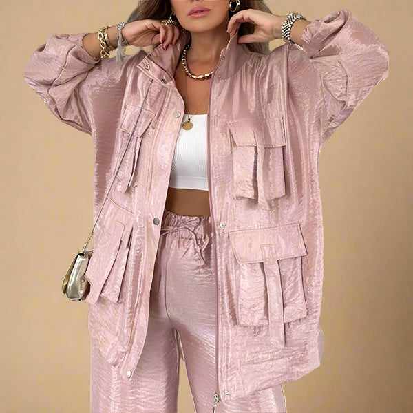 Person wearing a pink textured jacket and pants set indoors.