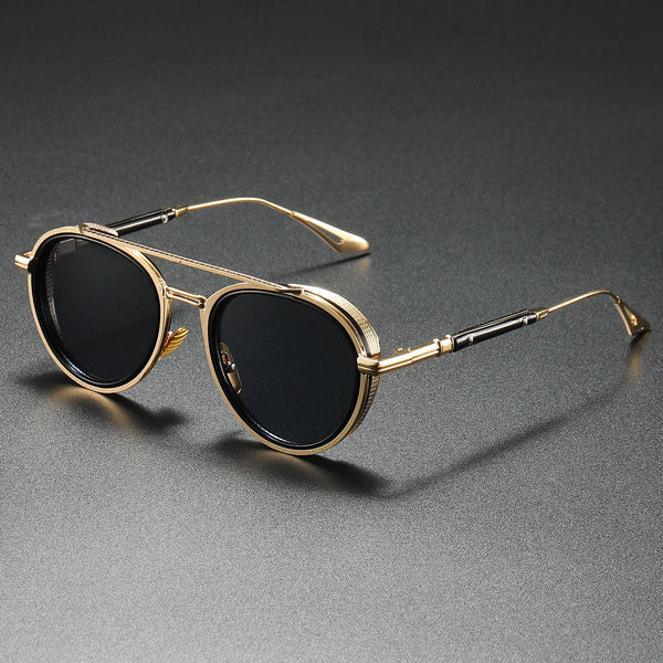 Gold-framed sunglasses with black lenses on a gray background