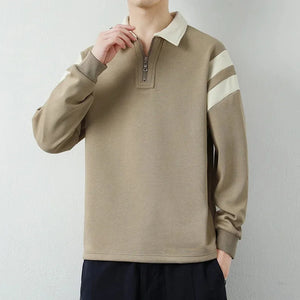 Beige long-sleeve shirt with white stripes on sleeves against a plain background