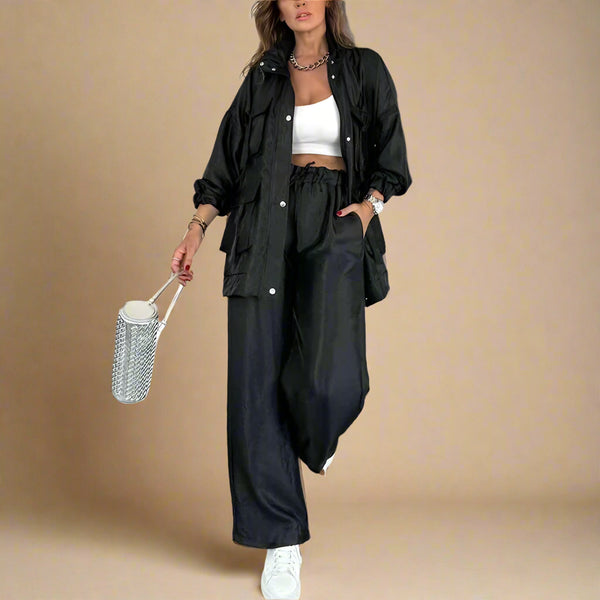Woman in black outfit with white top in a modern indoor setting