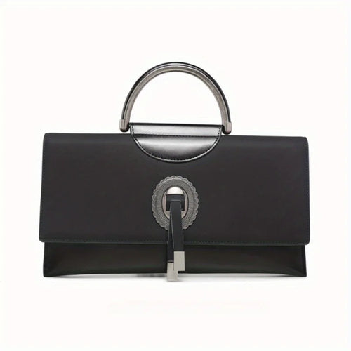 Black handbag with silver handle and clasp on a white background