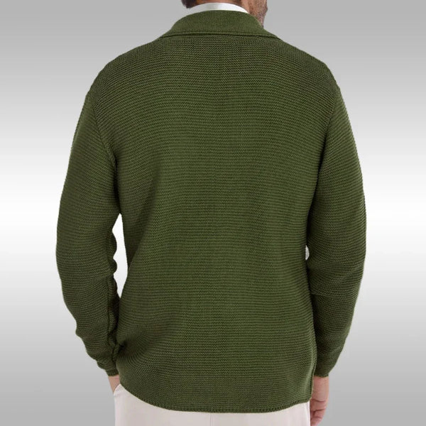 Green sweater worn by a person on a plain background