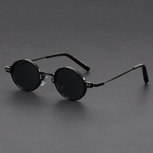 Round black sunglasses on a gray background
