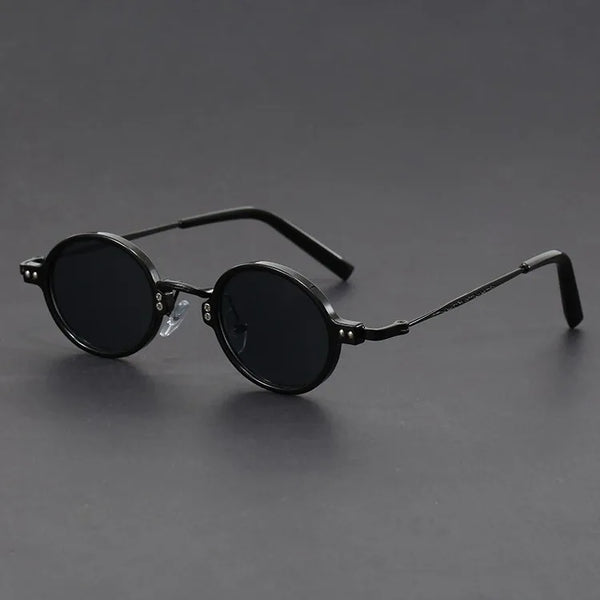 Round black sunglasses on a gray background