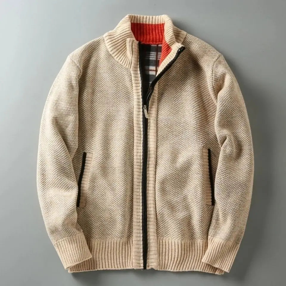 Man wearing a beige zip-up sweater against a gray background