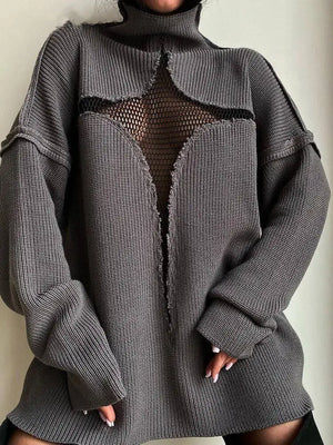 Person wearing a gray textured sweater with a mesh panel