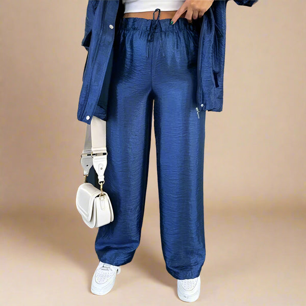 Person wearing blue pants and a blue jacket in an indoor setting