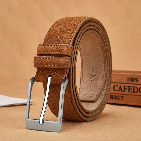 Brown leather belt with silver buckle on a beige background