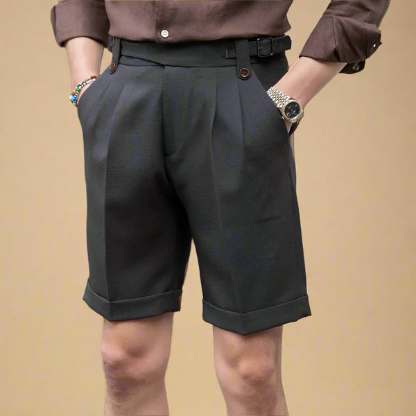 Person wearing dark gray shorts and a brown shirt on a street.
