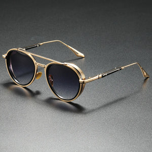 Gold-framed sunglasses with black lenses on a gray background