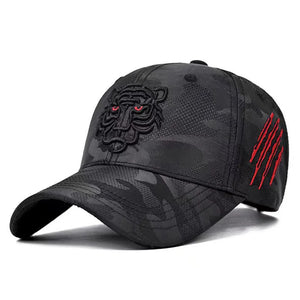 Black camouflage baseball cap with tiger emblem and red accents on a white background