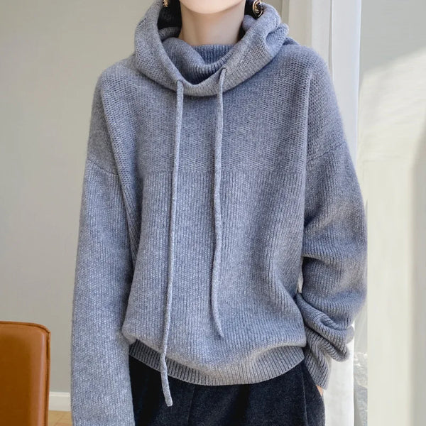 Gray hoodie worn by a person against a neutral background