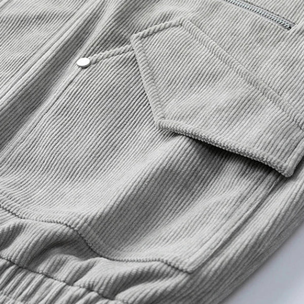 Close-up of a gray corduroy jacket with a pocket on a light background