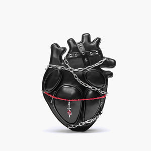 Black heart-shaped bag with chains and a red ribbon on a white background