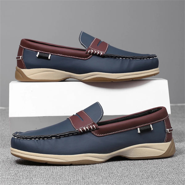 Pair of blue and brown loafers on a gray background