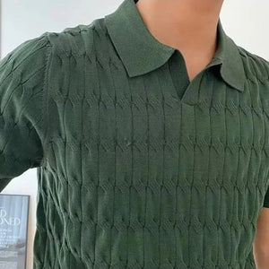 Green textured shirt worn by a person with a blurred background