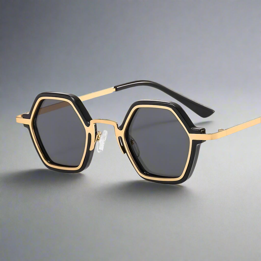 Sunglasses with gold frame and black hexagonal lenses on a white background