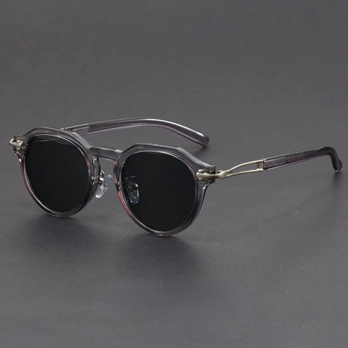 Round sunglasses with dark lenses on a gray background