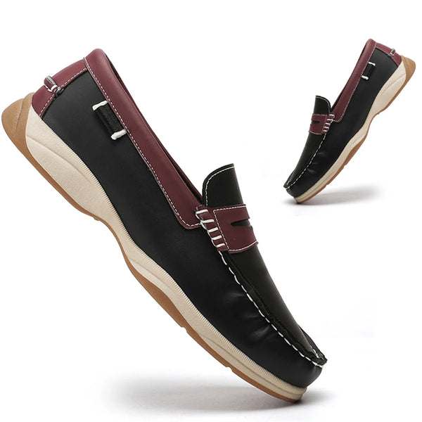 Black loafers with maroon accents on a white background