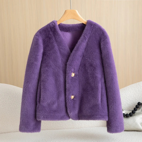 Purple fluffy cardigan on a wooden hanger against a beige wall.