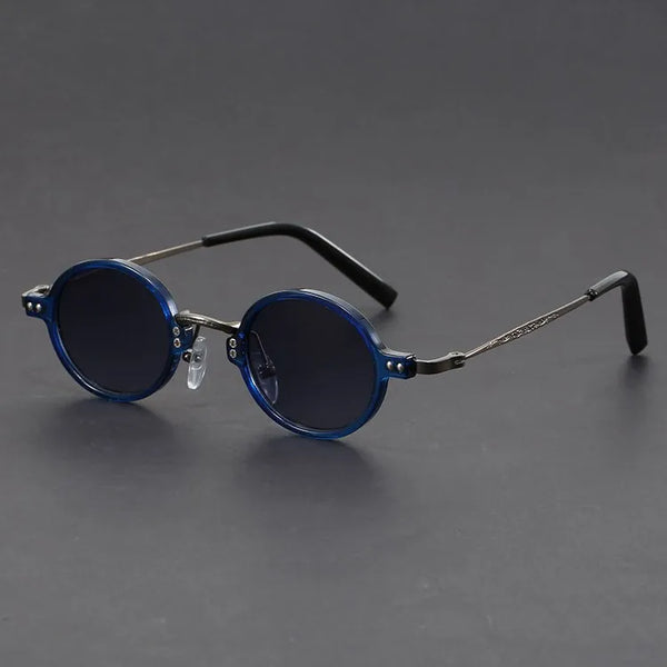 Round blue sunglasses with thin metal frames on a gray background