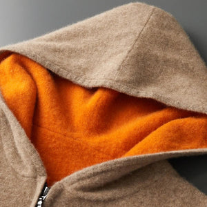 Close-up of a brown and orange fleece jacket with a zipper on a gray background