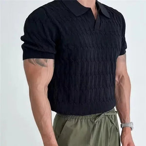 Person wearing a black textured short-sleeve shirt and green pants on a light gray background