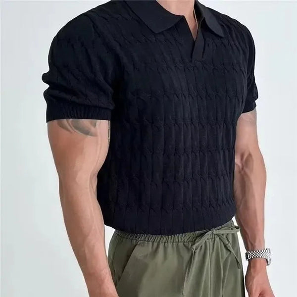 Person wearing a black textured short-sleeve shirt and green pants on a light gray background