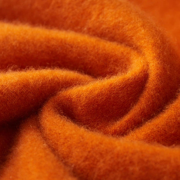 Close-up of orange fabric with a textured pattern