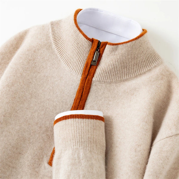Close-up of a beige sweater with orange trim on a white background