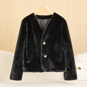 Black fur coat with gold buttons on a beige background
