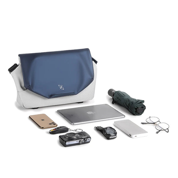 Blue and white bag with various items on a white background