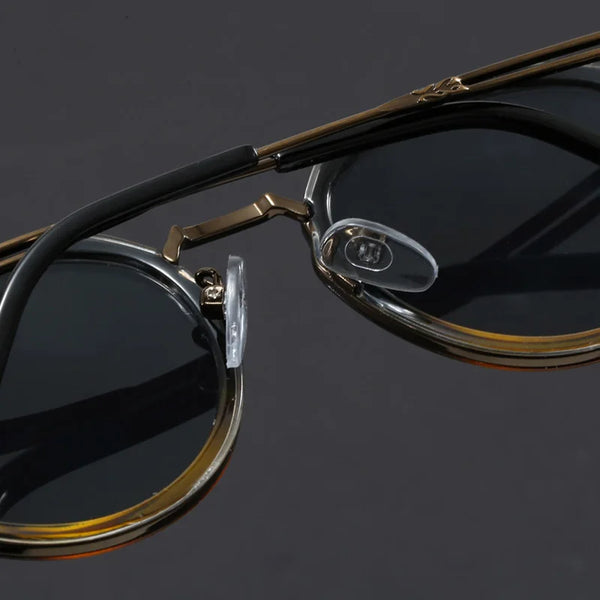 Eyeglasses with gold frame on a reflective black surface