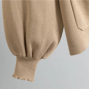 Close-up of beige pants with a plain background