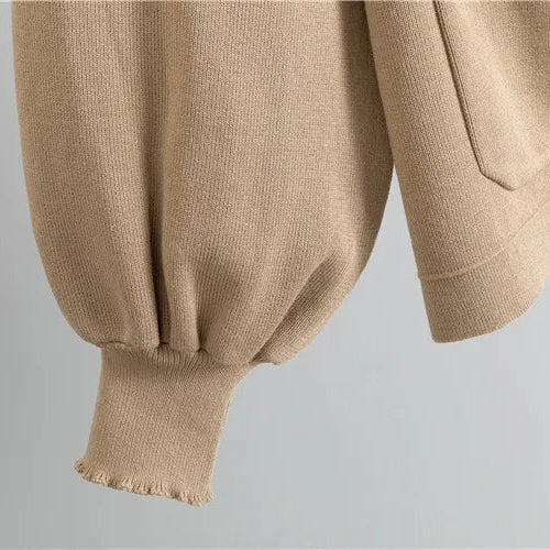 Close-up of beige pants with a plain background
