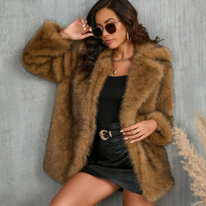 Woman wearing a brown fur coat against a gray wall