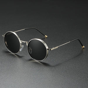 Round sunglasses with metallic frame on a dark gray background