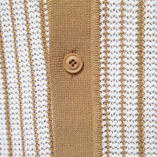 Close-up of a textured fabric with brown and white stripes and a button.
