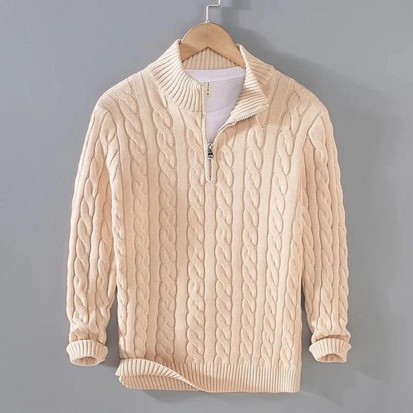 Beige cable knit sweater with a zipper on a gray background