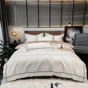 Neatly made bed with white bedding in a modern bedroom setting.