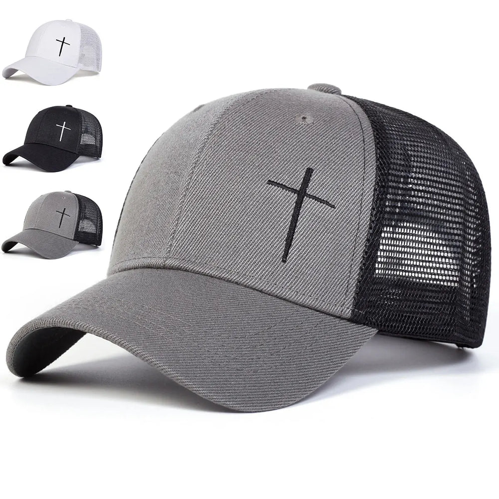 Man wearing a two-tone cap with a cross design on a neutral background